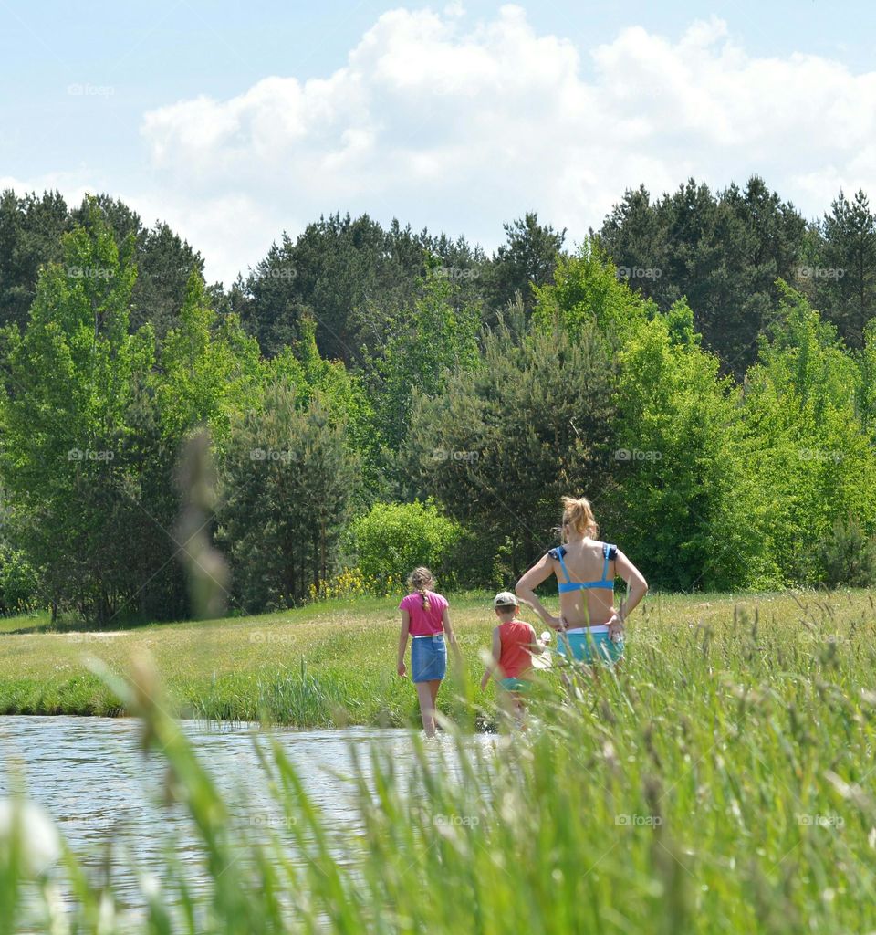 family relaxing on a lake view from the ground