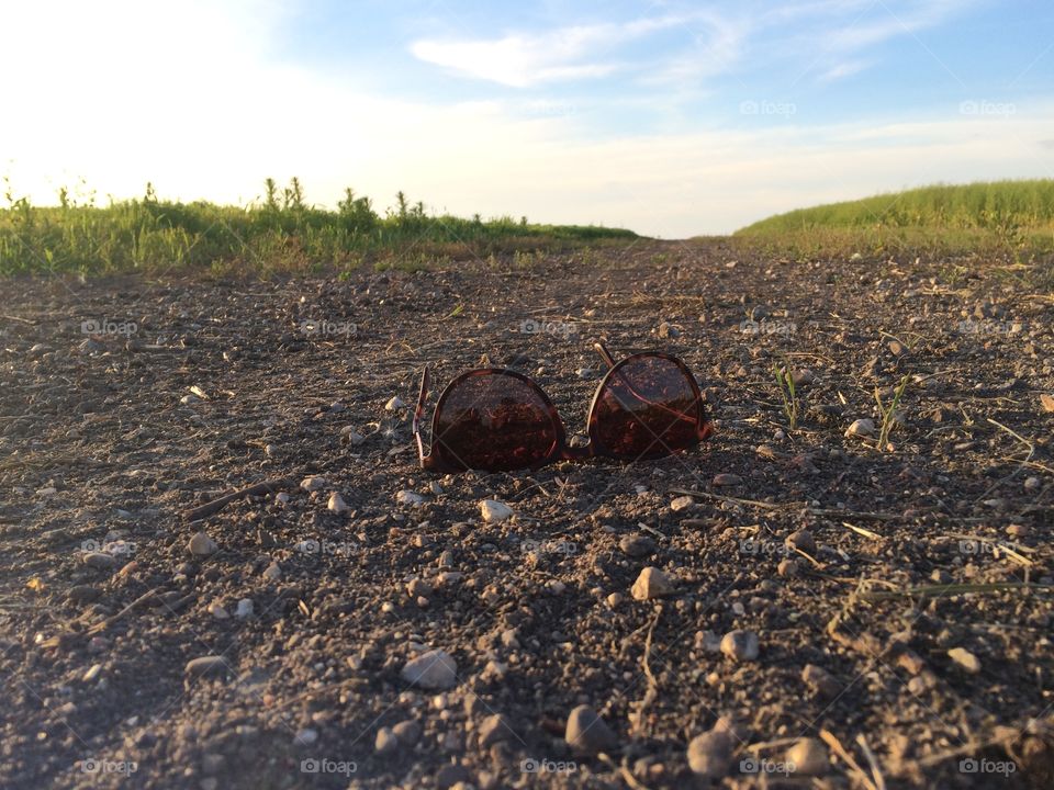 Sunglasses on a dirt road