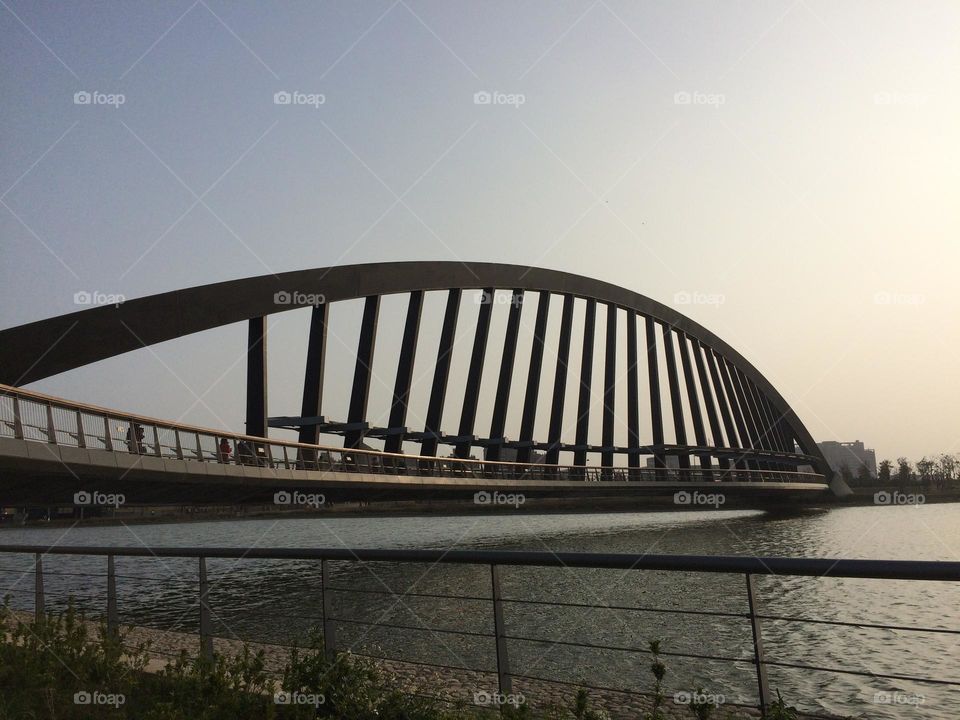 Modern bridge over the water with curves and angles 