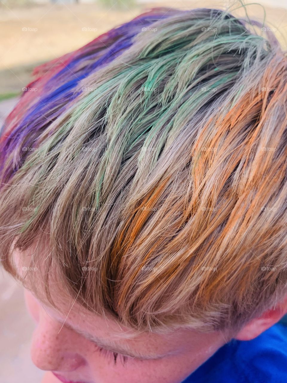 Child painter on Rainbow colored hair 