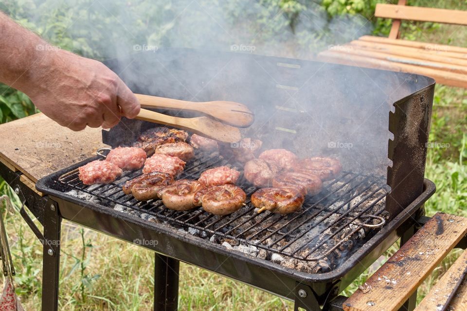 Enjoying the suny day and having barbecue outdoor 