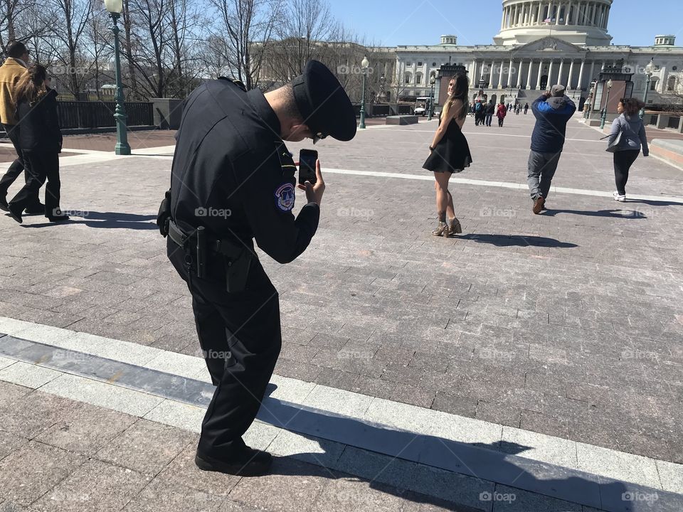 US Capitol police man snapping pictures of pretty girl. 