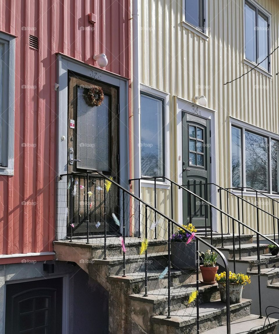 House with spring flowers and feathers at the stairs