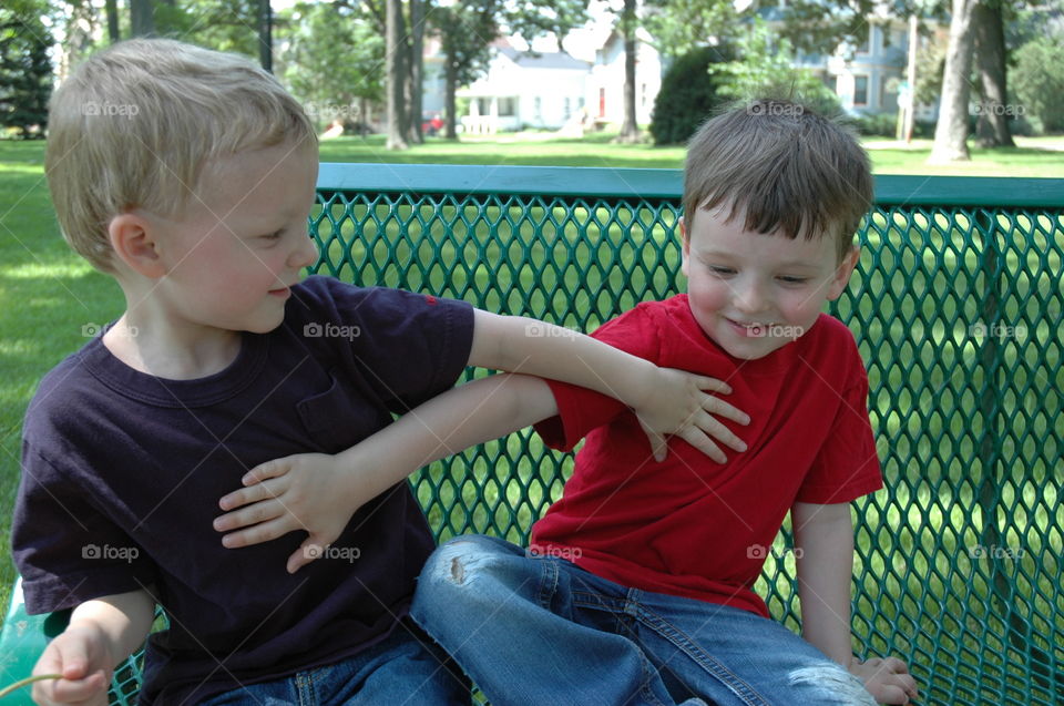 Brotherly Love. Brotherly Love.  Playing on a bench in a downtown City Park.