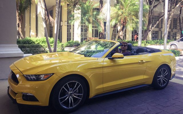 Man driving yellow car