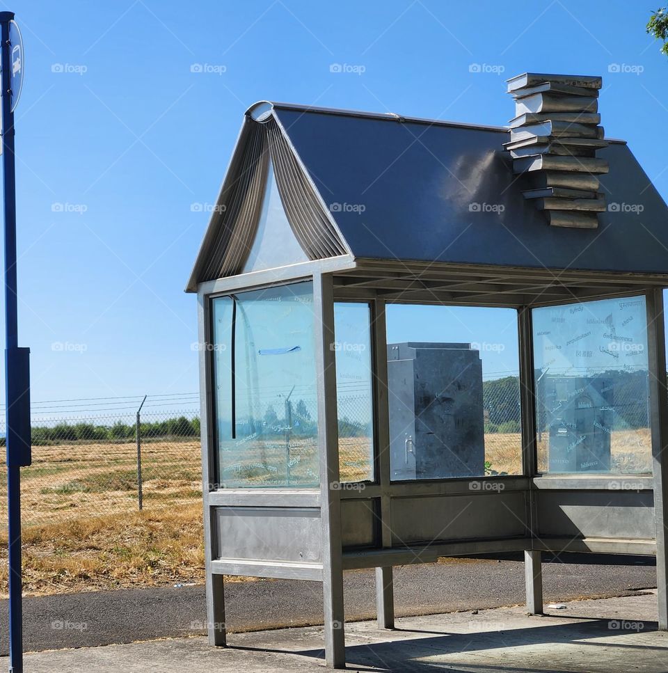 This charming structure featuring stacked books is a fun place to wait for a bus across from a library in Oregon