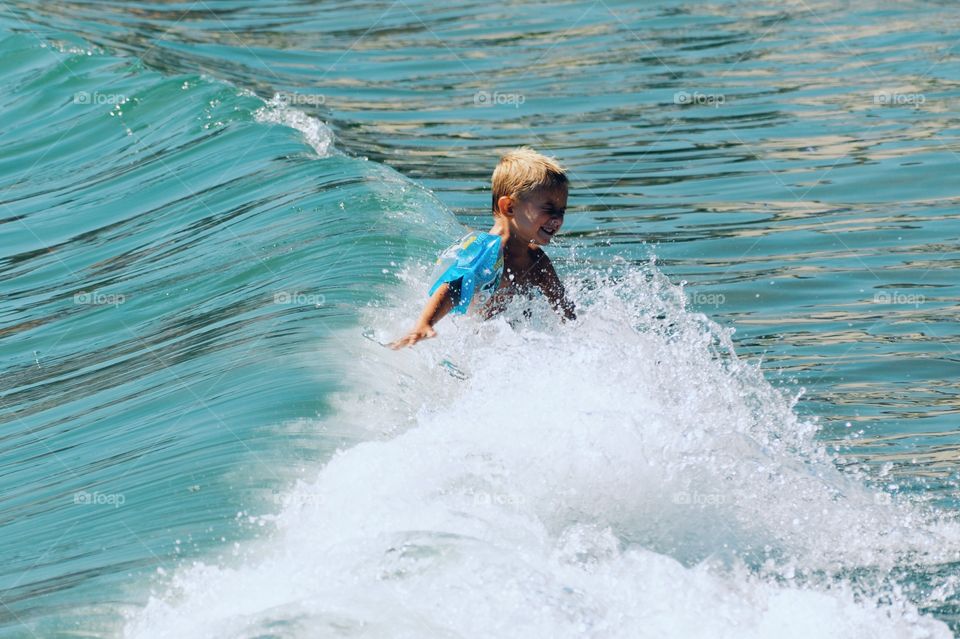 Little boy swimming in sea