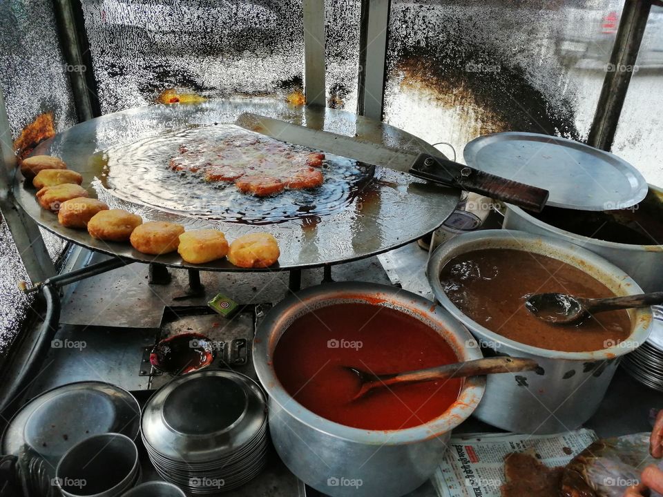 Frying Aloo or potato with hot oil in street stall and fried these potato and lead to making of Aloo  tikki or potato tikki chaat also called Indian  street snacks