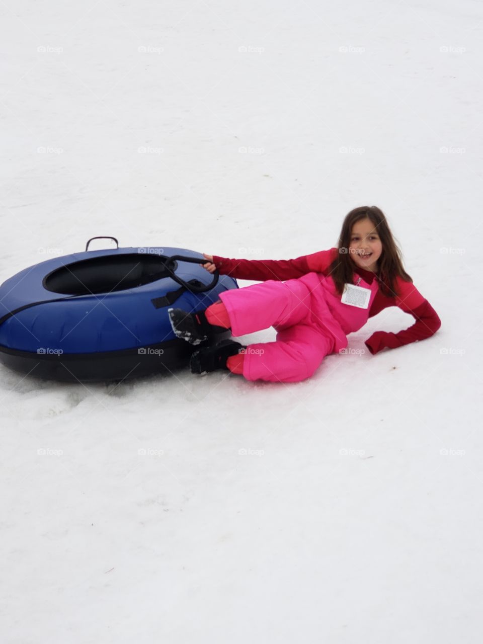 girl laughing and playing in snow