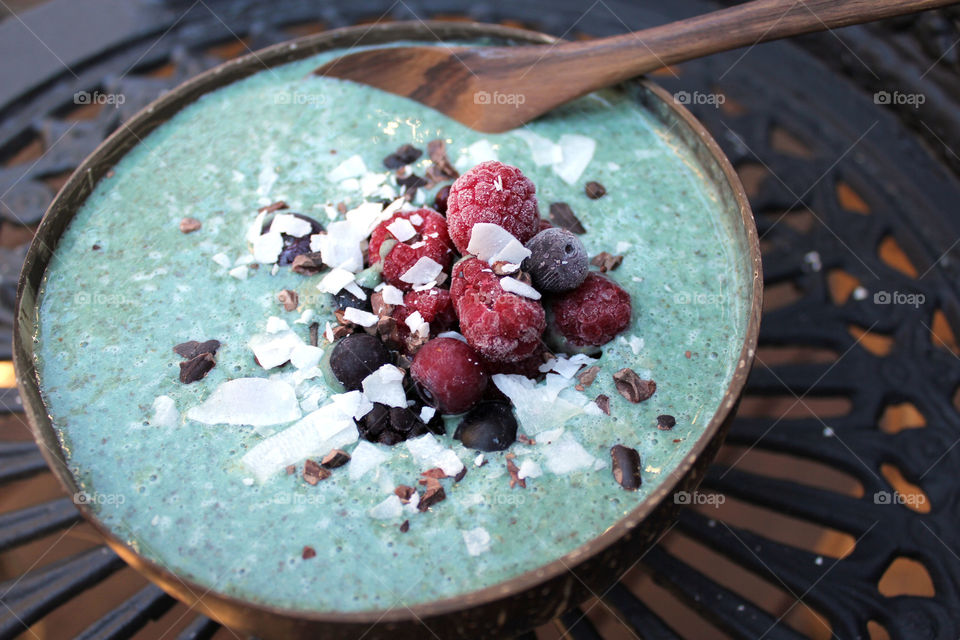 blue spirulina smoothie bowl with berries and coconut