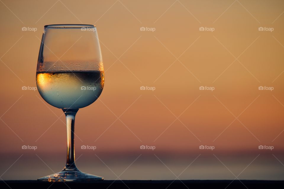 Glass of unoaked Chardonnay at sunset 