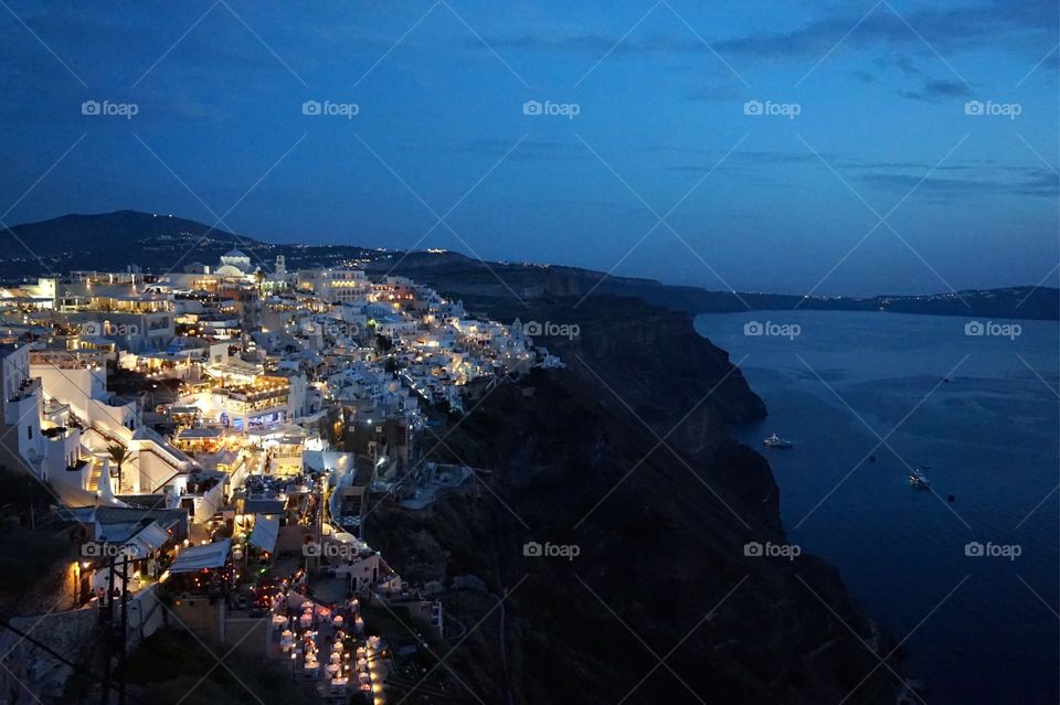 The lights of Fira at dusk, Santorini, Greece 