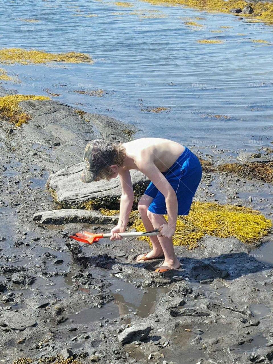 boy looking for clams