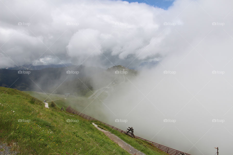 Hiking trail in the mountains at high altitude among the clouds 