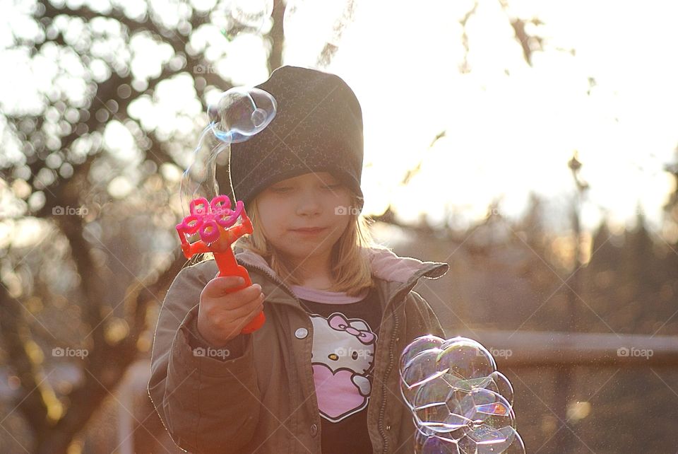 Child blowing bubbles