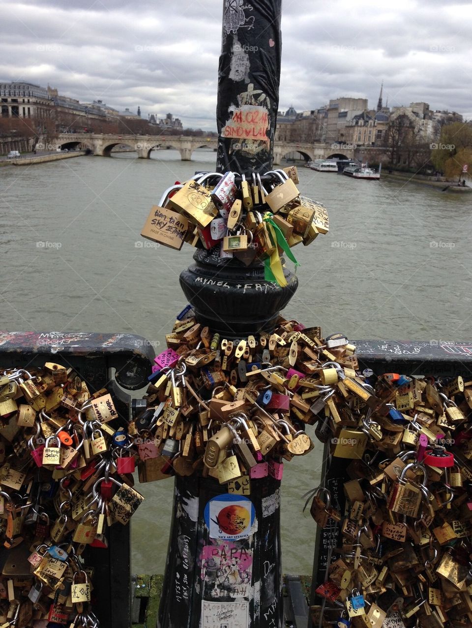 Love padlocks/ locks on the bridge Pont des Arts, across the river Seine in Paris, France