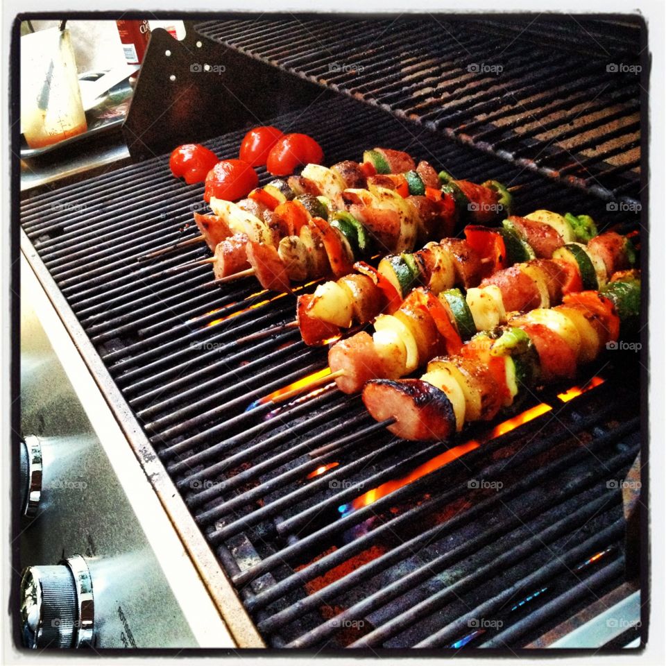 Grilling shish kebabs. Summer evening grilling with family and friends. 