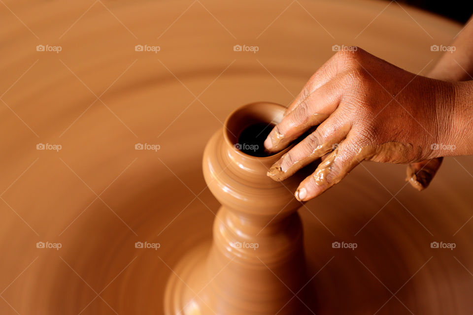 Potter making a clay pot