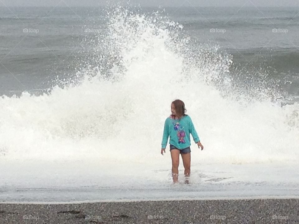Girl enjoying ocean waves