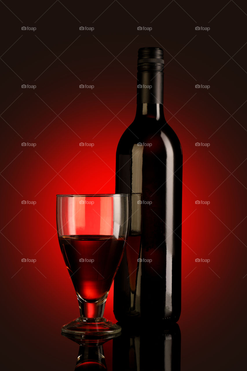 Red wine glass and bottle