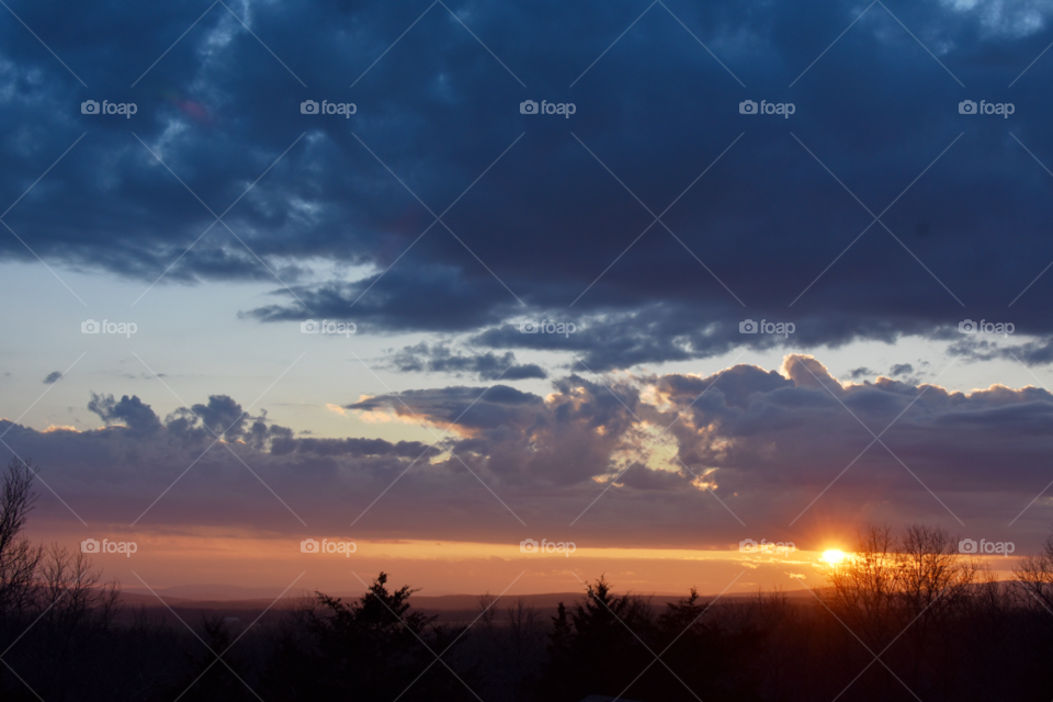 Scenic view with sunset colored clouds