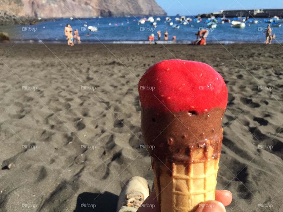 Hands Holding ice cream with Beach and Sea view