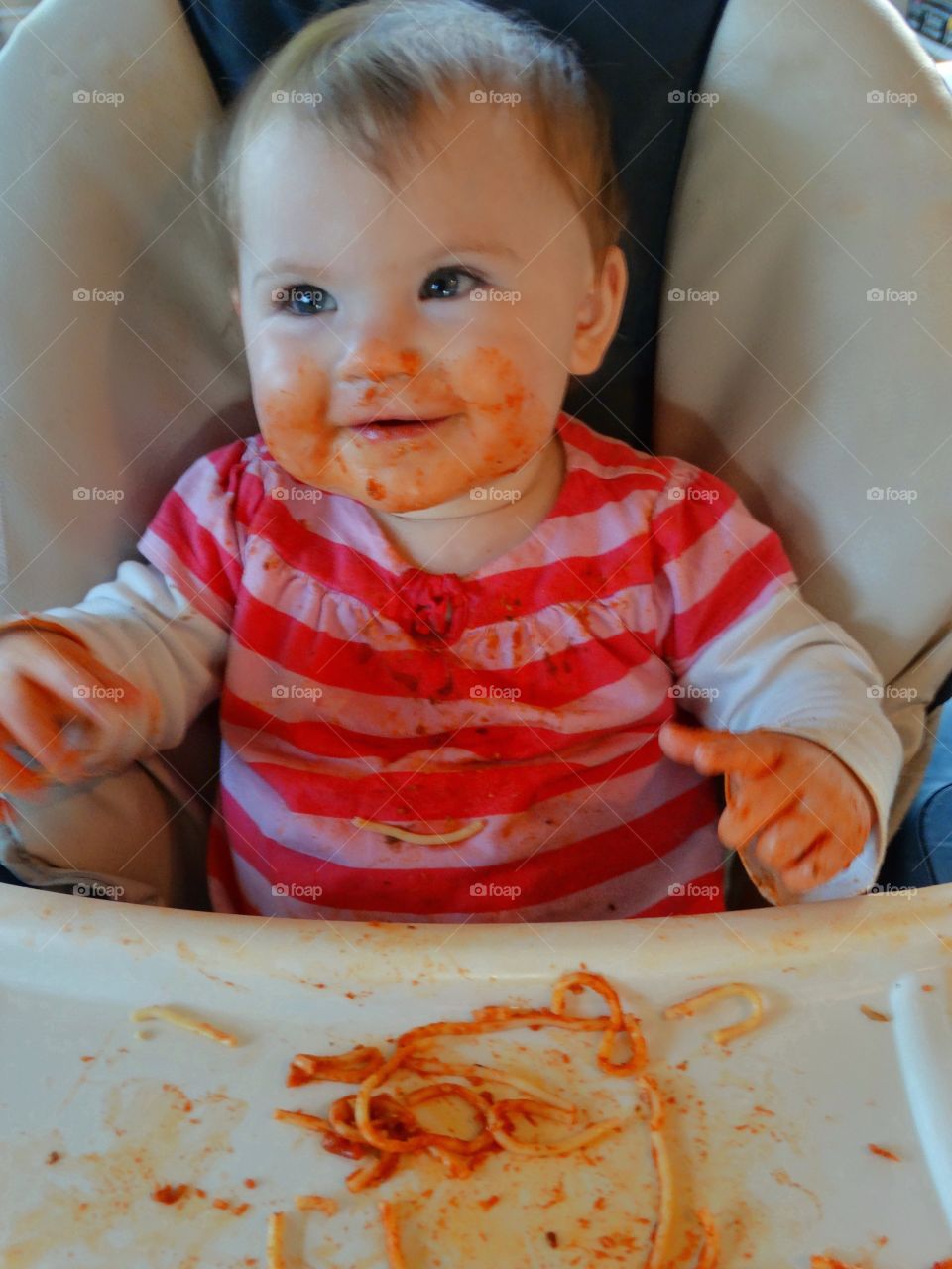 Messy Baby With Spaghetti Sauce On Face