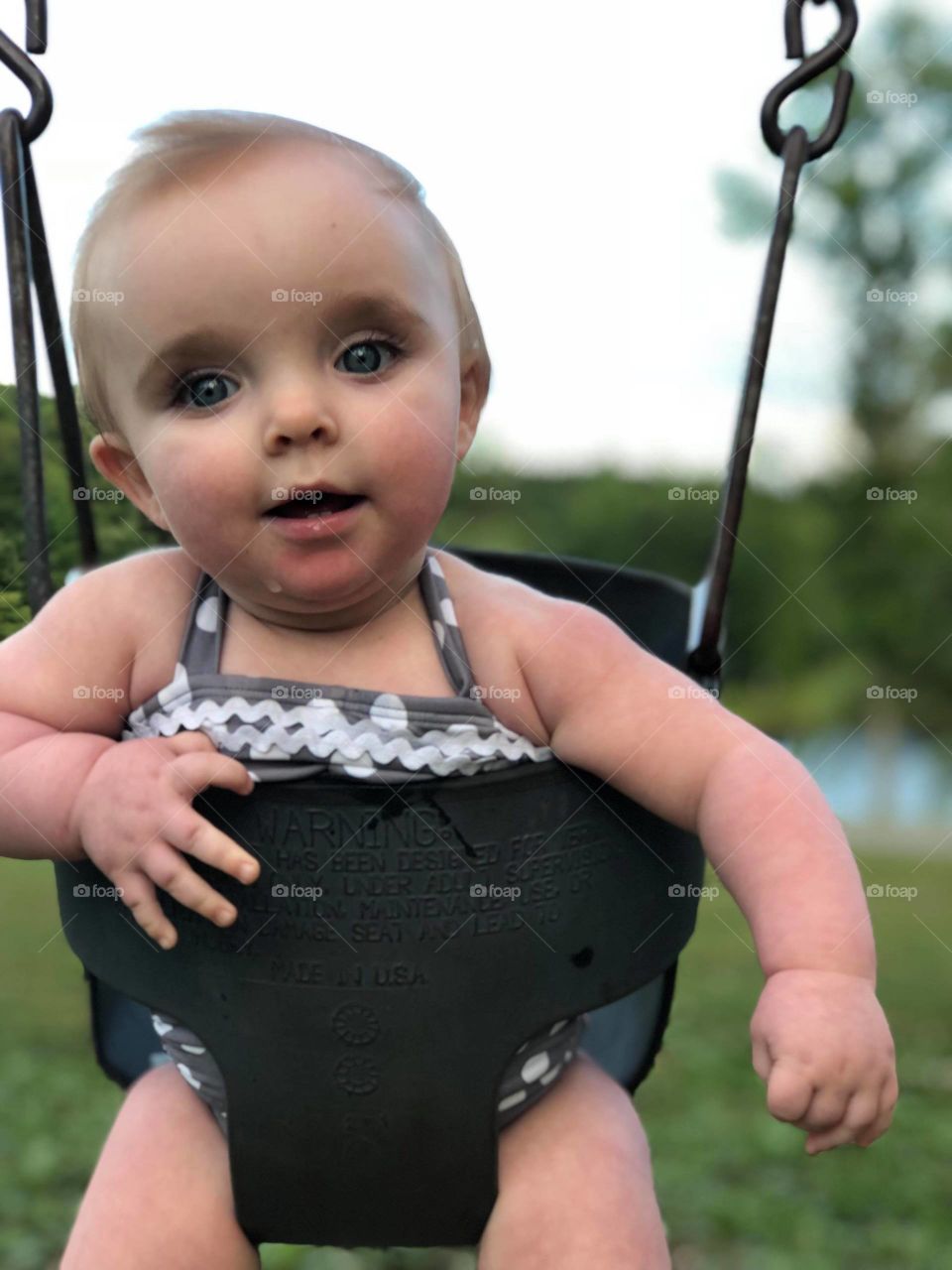 8 months old and loves to swing. I'm so in love with this picture because not only did it capture her beauty but it is as if time just stood still