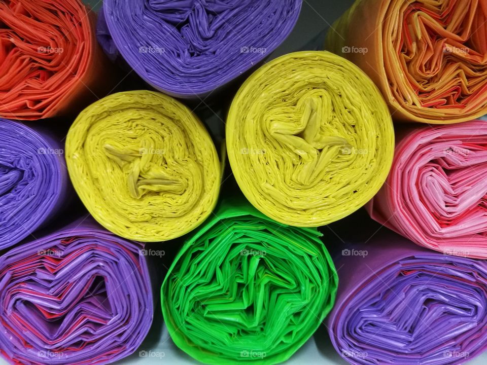 Stack of rolled and colored plastic bags