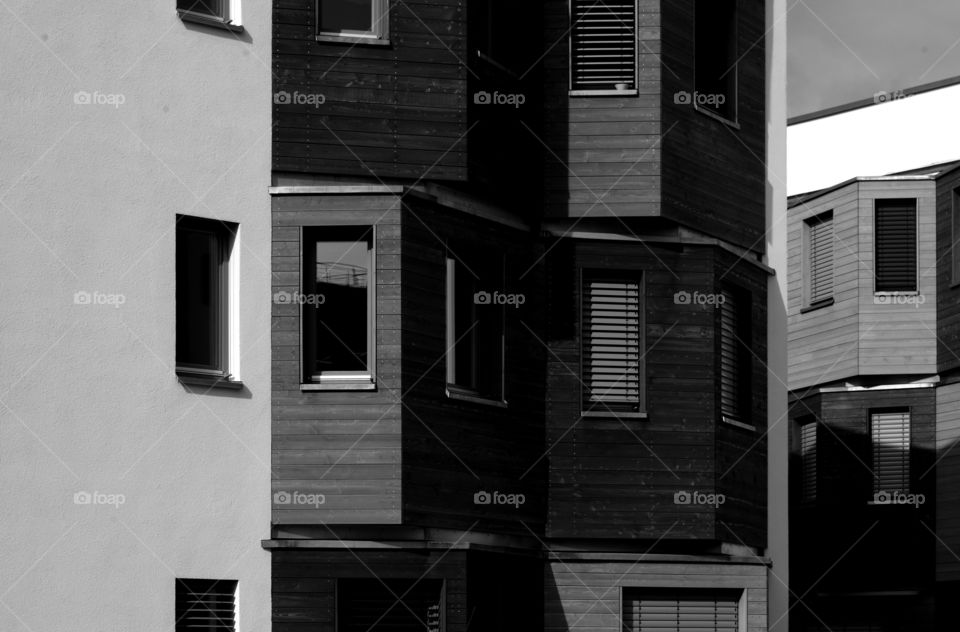 Black and white view of building exterior at day.