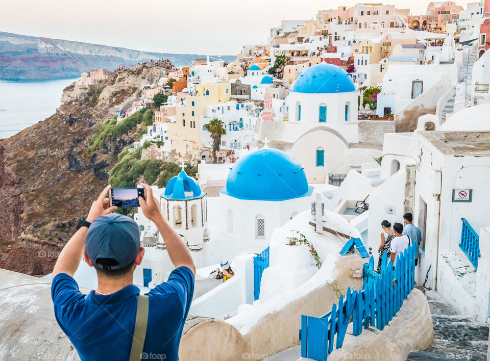 Man Taking Photo With Smartphone In Famous Greek Island Santorini