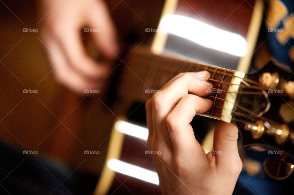 Hands playing guitar