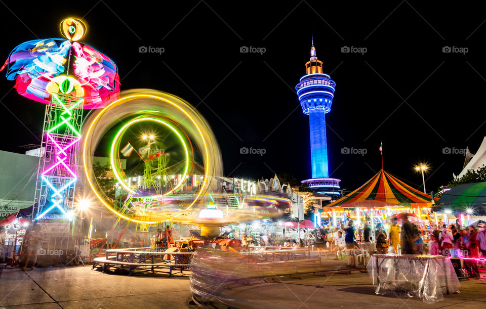 Colorful night...Thailand-October 15 2020:Colorful background of tents and Ferris wheel at annual celebration of Phra Samut Chedi at Samut Prakan Province