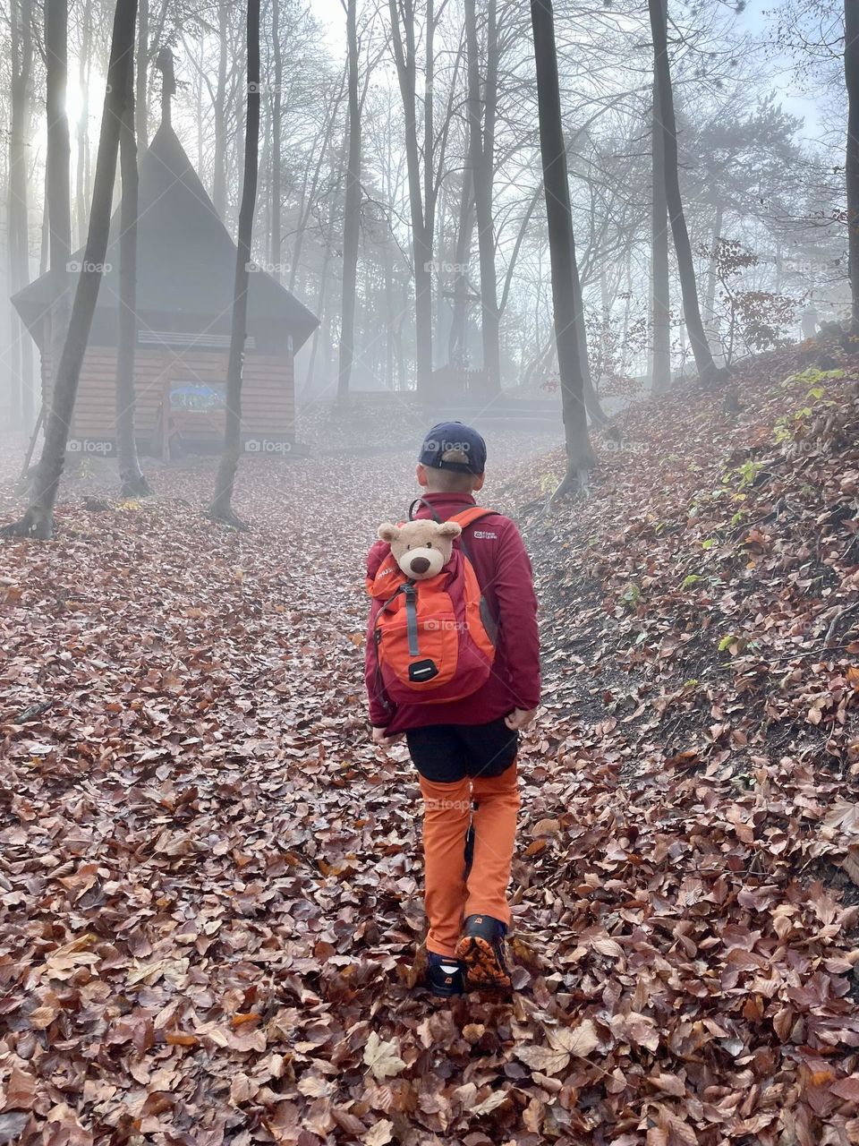 Boy and a bear. Mysterious house in deep forest. Autumn. 