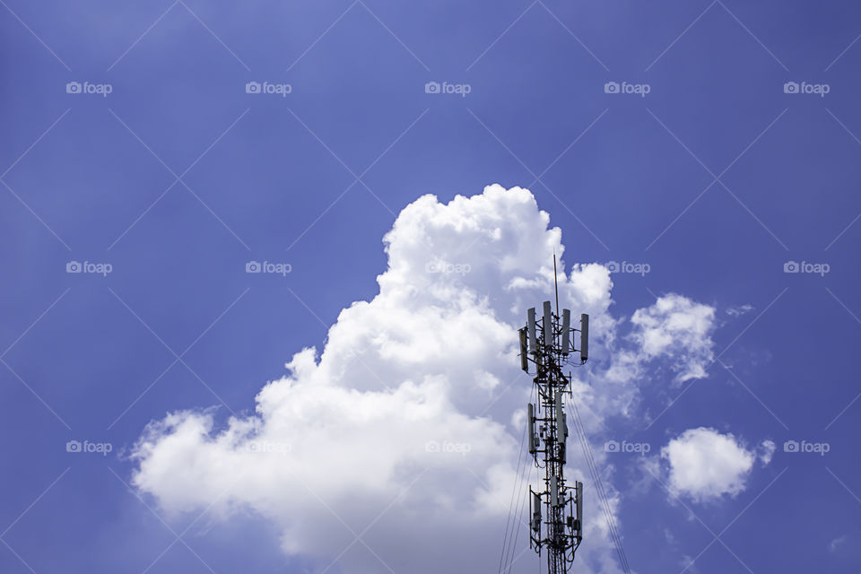 Wave transmission mast large phone signal with a bright blue sky.