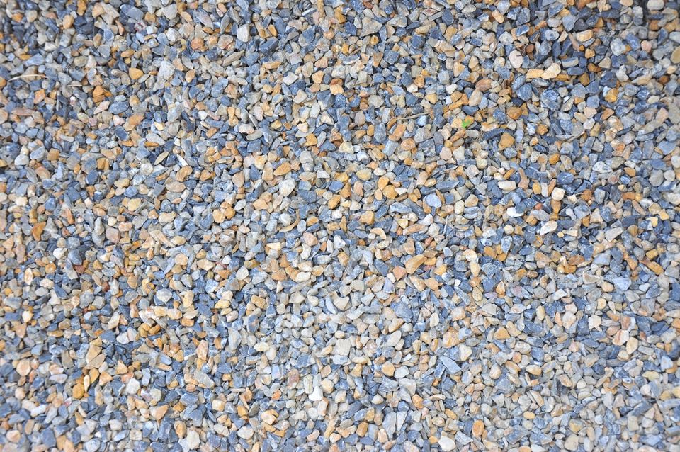 Road gravel texture. Gravel background. Blue, white, and brown gravel texture wallpaper. Coarse gravel.