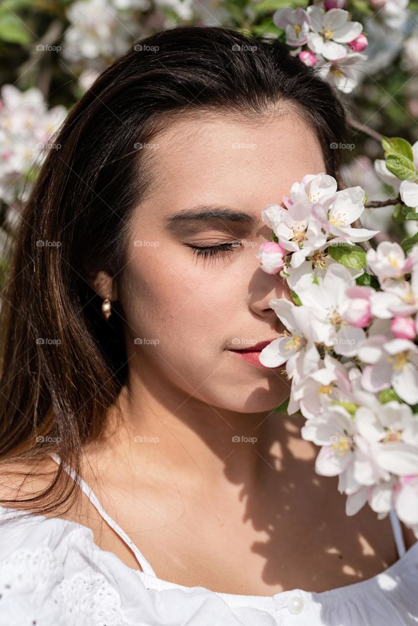 beautiful woman in spring blossom trees