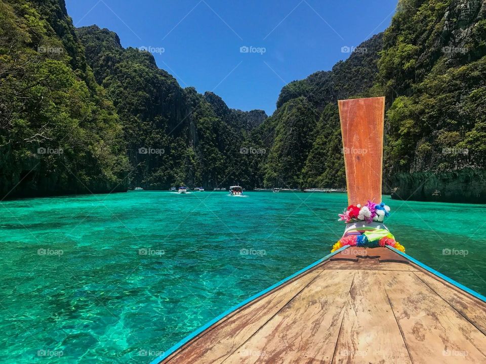 On a long tail boat in Thailand in a gorgeous lagoon.