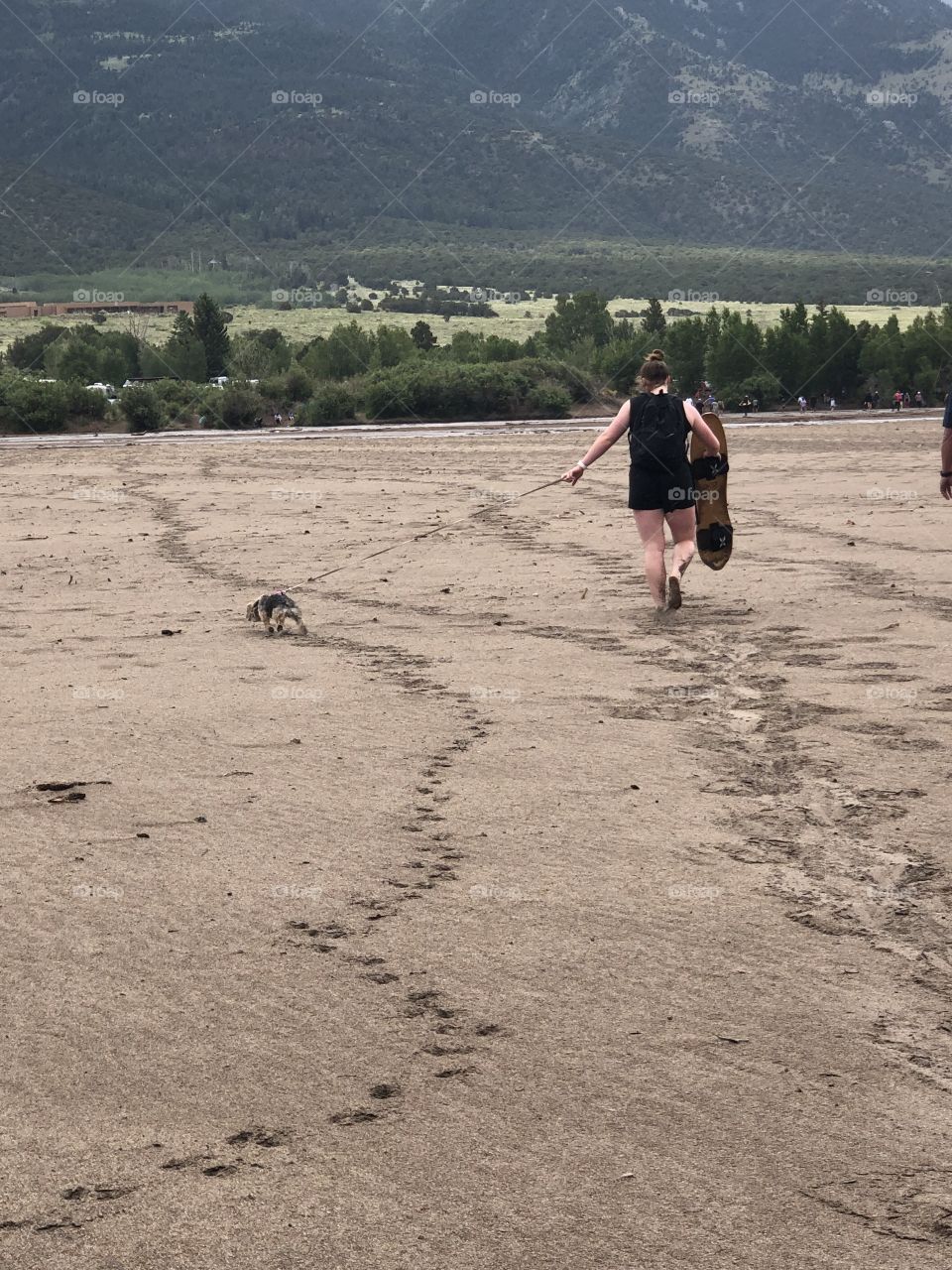 Young woman walking on the sand dunes in the Magical Outdoors.   