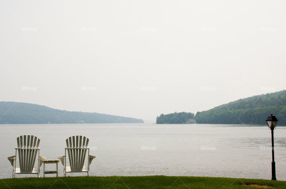To Adirondack chairs looking out over the lake