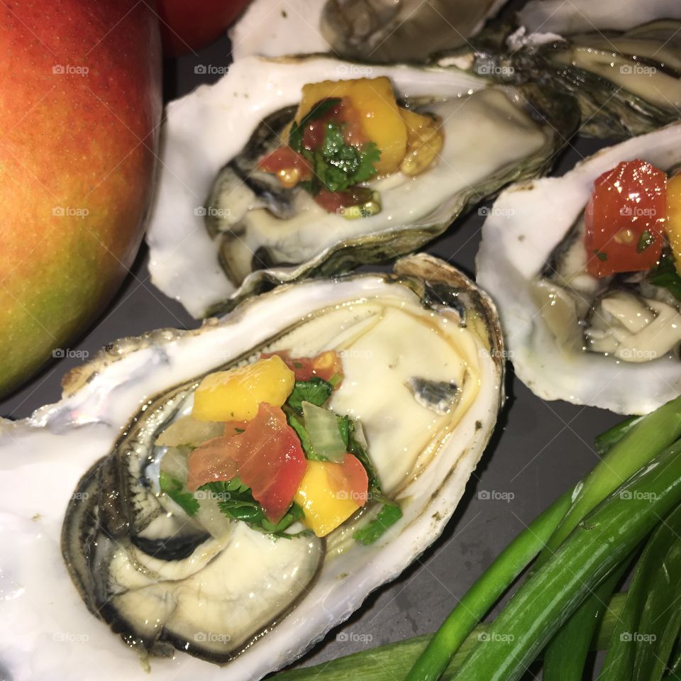 Fresh delicious oysters topped with a mango salsa that I whipped up 