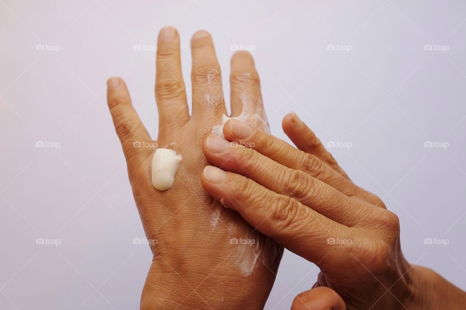 Woman puts hand cream