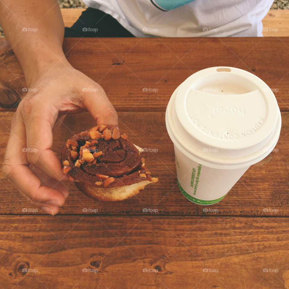 Breakfast sticky bun and coffee on wood table