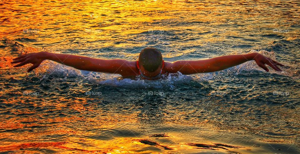 Swimming on sunset in Adriatic sea, Republic of Croatia.