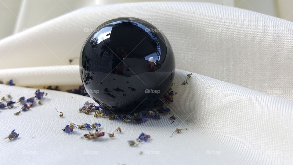 black obsidian, volcanic glass sphere.