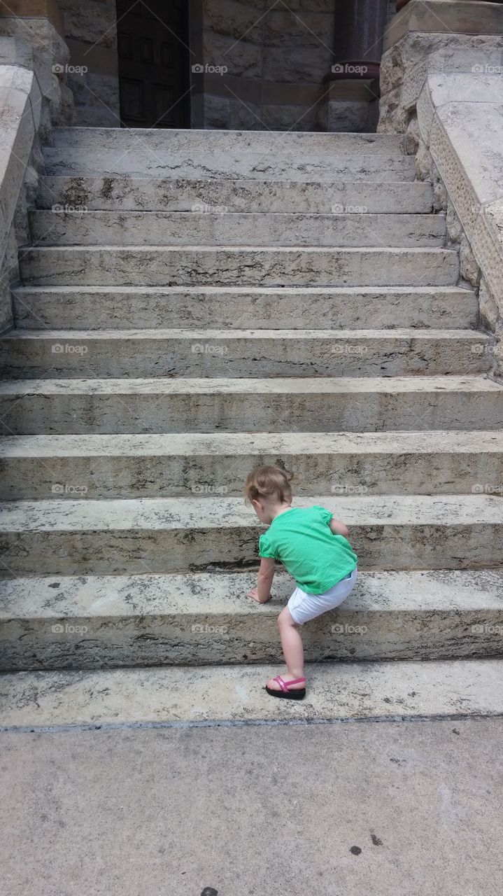 climbing to the top. child climbing stairs