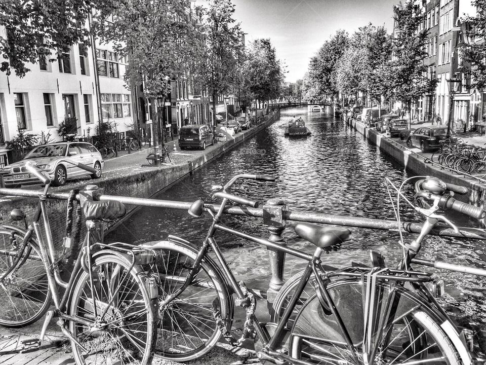 Bicycles parked against canal