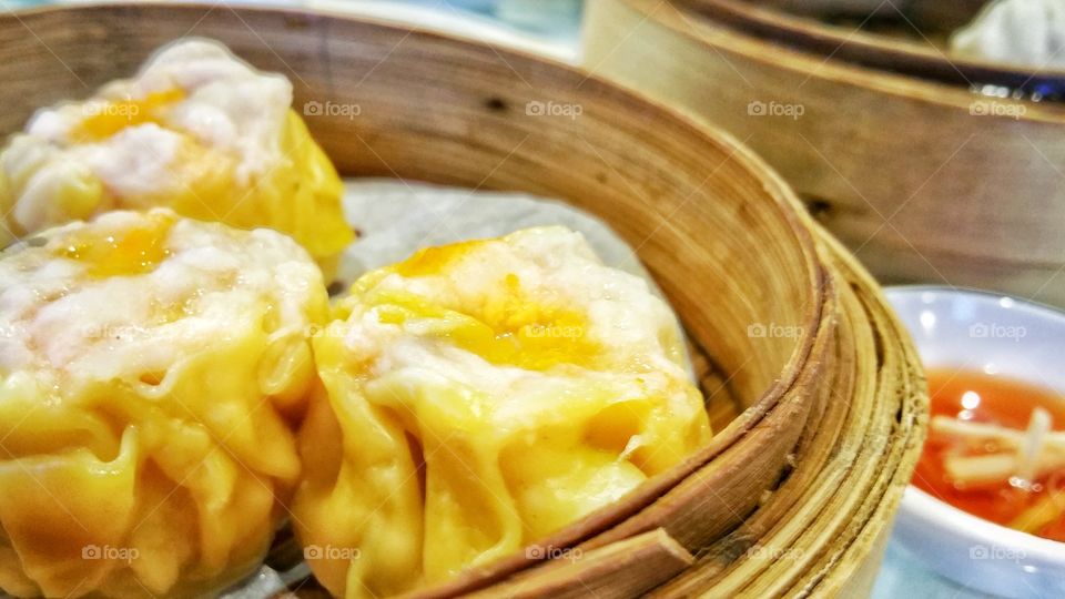 Pork and shrimp shumai or shaomai - a type of traditional Chinese dumpling originally from Hohhot, Inner Mongolia, China. Usually served as yum cha or dim sum snack in Cantonese cuisine.