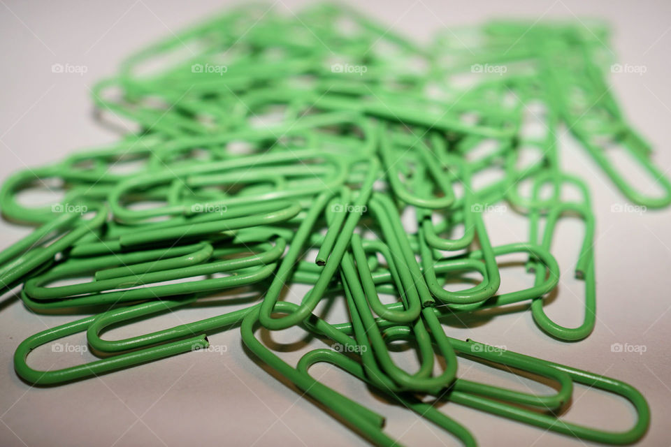 Close-up of green paper clips