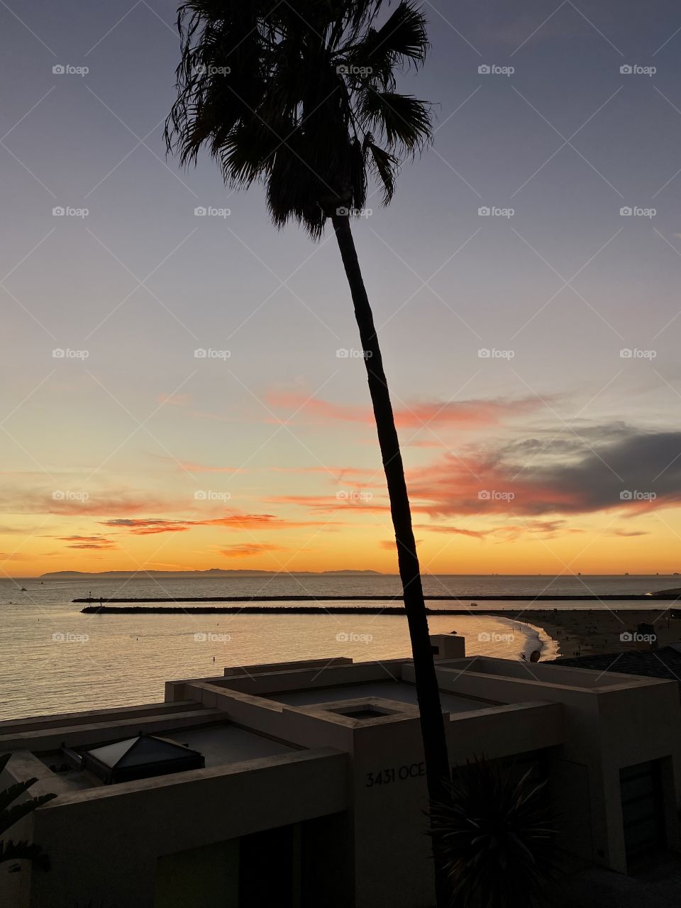 Beautiful sunset over a house looking over Corona del Mar State Beach from the Inspiration Point 